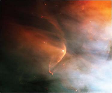 FIGURE 7.2 Bow shocks in the Orion Nebula. The large bow shock in the center and the smaller one above it form in front of invisible astrospheres surrounding two bright stars. SOURCE: Courtesy of NASA and the Hubble Heritage Team (STScI /AURA) and C.R. O’Dell (Rice University).