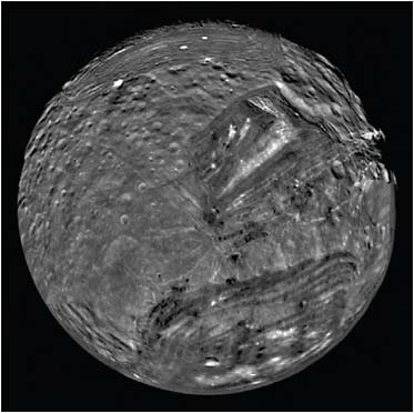 FIGURE 7.9 Uranus’ moon Miranda. Extensive geological activity in the past has created a complex surface on this tiny moon with a diameter of less the 500 kilometers. SOURCE: Courtesy of NASA/JPL.
