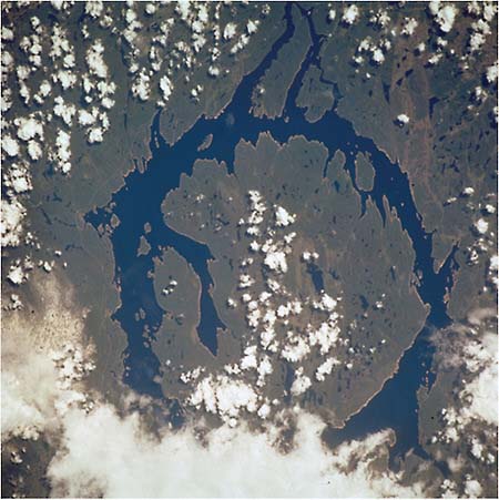 FIGURE 4.16 Manicouagan impact crater in the spring. Manicouagan Reservoir, Quebec, Canada, photographed by the STS111 crewmembers aboard the Space Shuttle Endeavour. NASA Photo ID: STS111-719061 (5-19 June 2002). SOURCE: Courtesy of NASA.