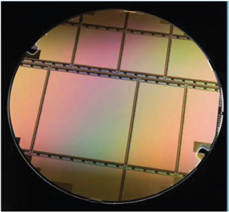 FIGURE 3-2 A single 8-inch ROIC wafer from 2007 Raytheon industry research and development. SOURCE: Angelo Scotty Gilmore, Stefan Baur, and James Bangs. 2008. High-definition infrared focal plane arrays enhance and simplify space surveillance sensors. Raytheon Technology Today 1:5-8. Available at http://www.raytheon.com/newsroom/rtnwcm/groups/public/documents/content/rtn08_tech_sensing_pdf2.pdf. Accessed March 26, 2010.