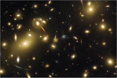 FIGURE 3.8 The gravitational potential of the cluster Abell 2218 (yellowish galaxies) acts as a cosmic lens, bending the light from background sources, magnifying them, and creating multiple and/or distorted images (bluish arcs). The curvature and displacement of the images contain enough information to reconstruct the smooth mass distribution and that associated with cluster galaxies. A gravitational lensing experiment on the smaller scale of galaxies will constrain the dark matter substructure predicted by numerical simulations. SOURCE: Courtesy of NASA, N. Benitez (Johns Hopkins University), T. Broadhurst (Racah Institute of Physics/Hebrew University), H. Ford (Johns Hopkins University), M. Clampin (STScI), G. Hartig (STScI), G. Illingworth (UCO/Lick Observatory), the ACS Science Team, and ESA.