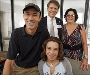 A non-directed donor can initiate a long donation chain. Pictured here (front, left to right) are the husband of the recipient of Matt Jones’s donated kidney, the 32-year-old woman to whom he donated his kidney, and the woman’s mother who would later become a donor herself. Surgeon Michael Rees stands behind. In all, 13 people received new kidneys in this chain.