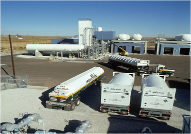 FIGURE 2.3 U.S. liquid helium plant (in the rear), helium tankers (attached to the truck and on the left), and International Organization for Standardization (ISO) containers for overseas shipment (middle and right). SOURCE: Air Products and Chemicals, Inc.