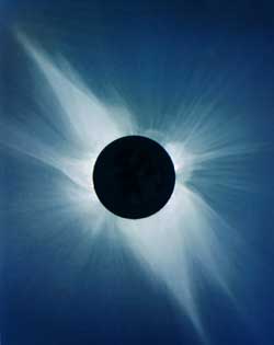 Pearly white streamers of the solar corona blaze across the darkened sky during a total solar eclipse.  Normally hidden in the Sun's glare, the outer atmosphere of our home star is visible to our eyes only when the Moon blots out the solar disk.