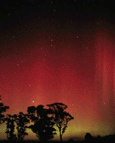 Familiar to inhabitants of the Northern Hemisphere as the Northern Lights, the dancing sheets of excited atmospheric particles called auroras also occur in the Southern Hemisphere. Here they color the Australian sky an eerie red.
